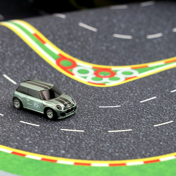 The Lacatang Shop's Turbo Mini Drift Scene Remote Control Car Track features a mini toy car, ready for action on winding curves adorned in green, yellow, and red—a perfect stage for racing thrills.