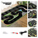 A collage displays images of the Lacatang Shop Turbo Mini Drift Scene Remote Control Car Track, featuring a black and green design with intricate curves. The larger image shows the full layout, while smaller images spotlight sections and accessories like a charging cable and connectors.