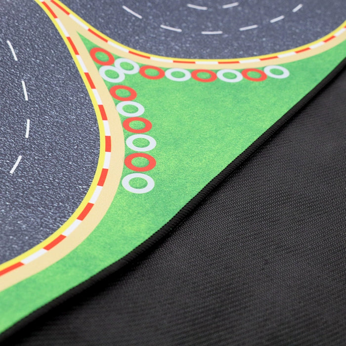 Close-up of Lacatang Shop's Turbo Mini Drift Scene Remote Control Car Track playmat, featuring a curved road with dashed lines, green grass, red and white markers, ideal for simulating an RC car track against a plain black background.