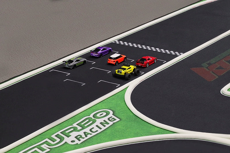 An aerial view of the "Turbo Remote Control Drift Car Track for All Ages" from Lacatang Shop shows five colorful cars—purple, green, orange, yellow, and red—at the starting line on a dark track with green-bordered edges featuring "Turbo Racing" text for an exciting race.