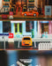 Close-up of a Turbo1/76 Miniature RC Remote Control Electric Sports Car from Lacatang Shop in three different scenes. The first shows the orange Toyota Mini at a toy gas station, the second on a miniature street with a parking spot, and the third with the "TURBO RACING" logo partly visible in the background.