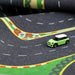 A Lacatang Shop Turbo Mini Drift Scene Remote Control Car Track features a small green toy car with a white roof on a playmat, complete with white dashed lines, colorful barriers, and sharp curves—perfect for immersing in drift racing.