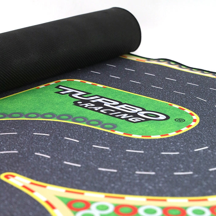 Close-up of a Lacatang Shop "Turbo Mini Drift Scene Remote Control Race Car Track" mat with a "Turbo Racing" green section, featuring gray, black, and white patterns with red and yellow edges. Ideal for high-speed racing RC cars.