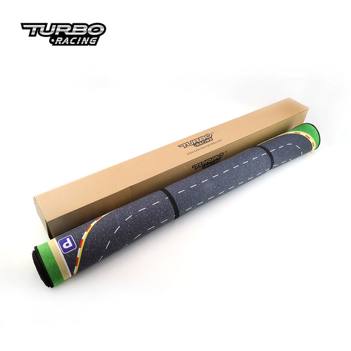 A Turbo Racing play mat, wrapped up beside its box, enhances the thrilling drifting experience with detailed road designs. It perfectly complements the Lacatang Shop's Turbo Drift Remote Control Car Track for Big and Small Scenes, making it a must-have for young racing fans.