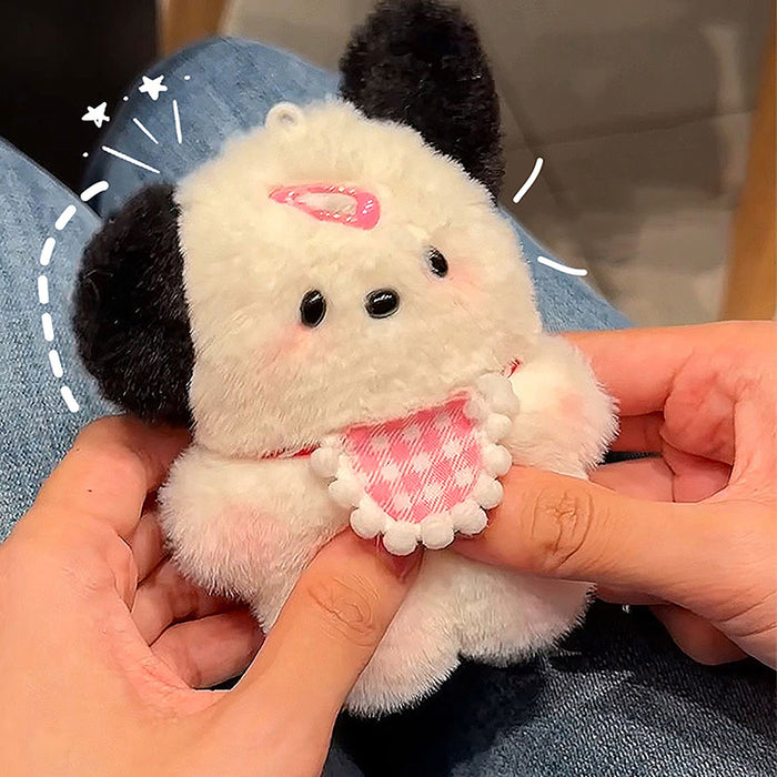 Someone holds the Cute Plush Puppy Keychain by Lacatang Shop, ideal as a birthday gift for women and girls. The adorable cartoon bag charm features black ears, a pink checkered bow tie, small pink patch, and star doodles. The background blurs to show someone's legs in jeans.