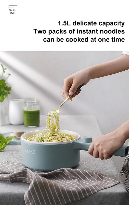 A person is using a fork to lift noodles out of a blue 2024 New Portable 1.5L Multi-function Pot Rice Cooker Electric Cooking Stir Frying Noodle Pot Mini Hot Pot Household Dormitory from Lacatang Shop, placed on a table. A jar of green sauce and a plant are in the background. The text on the image reads, "1.5L delicate capacity. Two packs of instant noodles can be cooked at one time.