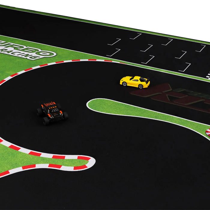 The Lacatang Shop's Turbo Racing 1:76 Drift Track features two remote control cars—one yellow and one black—on a track with red and white borders, set against a green and black background with labeled lanes and racing decals.