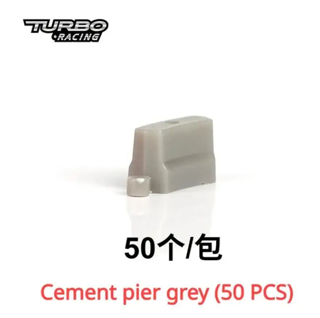 Image of a grey cement pier block with a small cylindrical piece. Text reads "Turbo Racing" and "Cement pier grey, 50 PCS" in red—ideal for customizing your Lacatang Shop's TURBO RACING 1:76 Scale Remote Control Car Track Kit with Drift Jump and Cement Blocks.