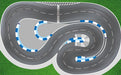 Aerial view of Lacatang Shop's 2.4m Drift Racing Track, designed for RC cars like Kyosho Mini-Z and WLtoys, featuring winding gray roads with white dashed lines, blue and white striped barriers, and a checkered finish line on a grassy surface.