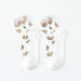 Lacatang Shop's Vintage Floral Lace Ruffle Socks exude Kawaii Harajuku style with delicate rose embroidery. The ultra-thin, transparent crystal silk crew socks feature a plain white background, enhancing their whimsical elegance.