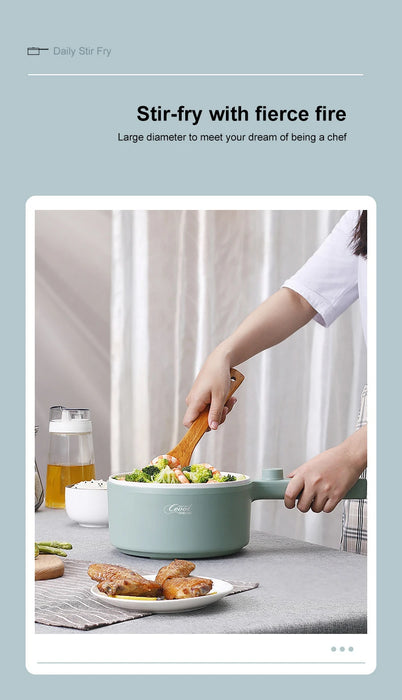 A person dressed in a white shirt is using a wooden spoon to stir vegetables in a light blue Lacatang Shop's 2024 New Portable 1.5L Multi-function Pot Rice Cooker Electric Cooking Stir Frying Noodle Pot Mini Hot Pot Household Dormitory. The pot is placed on a table alongside cooked meat, toast, and glasses. In the background, there are text signs saying "Stir-fry with fierce fire" and "Large diameter to meet your dream of being a chef.