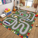 The VIKAMA Kids' Cartoon Traffic Play Mat by Lacatang Shop is a colorful car-themed carpet featuring a winding road with vehicles like cars, buses, and trucks. Placed on a wooden floor, it's complemented by nearby items like a guitar, suitcase, and window seat pillows.