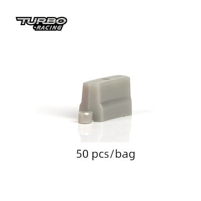 A gray plastic rectangular piece with a small metal component, perfect for Lacatang Shop's Turbo Drift Remote Control Car Track for Big and Small Scenes. The image displays the "Turbo Racing" logo in the top left, marked "50 pcs/bag," ensuring an exciting drifting experience.