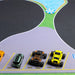 Toy cars from Lacatang Shop navigate a High-Speed Turbo Racing Remote Control Car Track (1600*900mm) with designated parking, curves, a lake, and simple road layout. The green, black with orange, and yellow models highlight thrilling performance on this play mat designed for 1/76 drift racing fun.