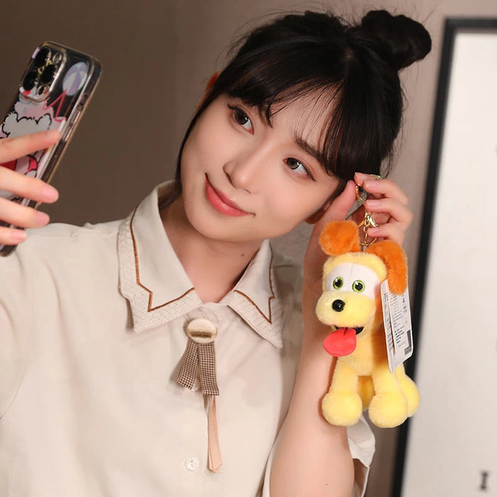 A woman with dark hair in a bun takes a selfie, displaying her cute style with a Lacatang Shop Kawaii Oudi Dog Plushie. Her collared shirt features ribbon details, while the plushie's orange ears and tongue charm make it ideal for anime fans.