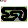 The Lacatang Shop 1/76 Scale Turbo Racing Rubber Mat for RC Mini Car Track features a black racetrack with red and white curbs on green, sharp turns, a start/finish line, 