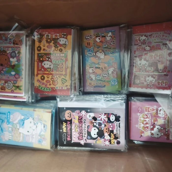 The Lacatang Shop's Kawaii Hello Kitty Sealing Stickers box is filled with colorful, cartoon-themed sticker sheets, featuring cute animal designs and Hello Kitty motifs. These are individually plastic-wrapped for decor in packaging and crafts.