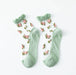 The Lacatang Shop's Delicate Vintage Floral Lace Ruffle Socks feature pastel green toes, heels, and cuffs with pink rose patterns and green leaves on sheer fabric, embodying kawaii Harajuku style.