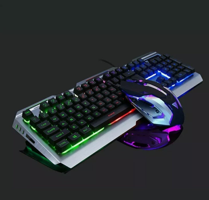 The Ninja Dragon Metallic Silver Mechanical Gaming Keyboard and Mouse Set by Yellow Pandora features a USB wired connection, multicolor backlighting on a dark background, and a sleek mouse design with Seven Color Breathing Light accents. The metallic frame of the keyboard is complemented by keys illuminated in various colors.