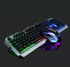 The Ninja Dragon Metallic Silver Mechanical Gaming Keyboard and Mouse Set by Yellow Pandora features a USB wired connection, multicolor backlighting on a dark background, and a sleek mouse design with Seven Color Breathing Light accents. The metallic frame of the keyboard is complemented by keys illuminated in various colors.